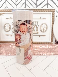 a photo on the side of a coffee cup is shown in front of a backdrop