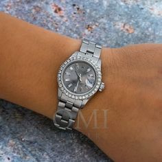 This pre-owned Rolex Lady-Datejust features a stunning gray custom diamond dial and a custom diamond bezel in stainless steel, offering a refined and elegant appearance. With a 26mm case and stainless steel bracelet, this watch combines classic style with contemporary luxury. The scratch-resistant sapphire crystal and automatic movement ensure both durability and precision. A stylish choice for a sophisticated women's watch, complete with its original Rolex box. Size: One Size.  Gender: female. Buy Rolex, Gray Diamond, Contemporary Luxury, Blue Beach, Pre Owned Rolex, Grey Diamond, Bezel Diamond, Women's Watch, Steel Bracelet