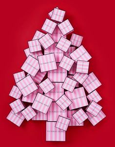 a christmas tree made out of pink and white boxes