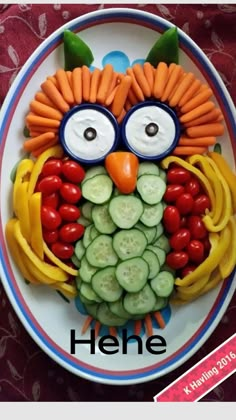 a plate that has some vegetables on it and an owl face made out of carrots