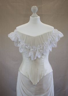 "This natural form era wedding dress was inspired by \"The Age of Innocence\" (1993) movie by Martin Scorsese. Its forms and lines reminiscent of late 1870s - early 1880s graceful silhouettes. Gentle vanilla colour and white laces makes it suitable for bride, though it can be used as a special occasion ball gown too. The dress consists of the bodice and skirt. The bodice is lined with coton and has boning. The costume is designed to be worn with proper period undergarnments (bustle or 'omar tail Regency Style Wedding Corset With Historical Design, Regency Style Historical Wedding Corset, Regency Style Wedding Corset With Boned Bodice, Victorian Overbust Wedding Bodice, Victorian Wedding Dress With Fitted Bodice, Victorian Dress With Fitted Bodice For Wedding, Fitted Victorian Wedding Dress With Overbust, Vintage Victorian Dress With Fitted Bodice And Overbust, Victorian Overbust Wedding Corset