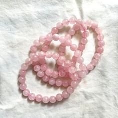 Elevate your style and well-being with our Pink Rose Quartz Bracelet. This exquisite bracelet features genuine rose quartz beads, renowned for their ability to attract love, promote emotional healing, and create a sense of calm. The soft pink hues of the rose quartz beads add a touch of elegance to any outfit, making it suitable for both everyday wear and special occasions. Our skilled artisans handcraft each bracelet with attention to detail, ensuring that you receive a unique piece that carrie Pink Rose Quartz Bracelets For Meditation, Rose Quartz Round Crystal Bracelet For Meditation, Pink Rose Quartz Bracelet For Meditation, Rose Quartz Crystal Bracelet For Meditation, Round Rose Quartz Crystal Bracelet For Relaxation, Rose Quartz Gemstone Beads Bracelet For Meditation, Rose Quartz Beaded Bracelet For Meditation, Spiritual Rose Quartz Bracelet With Gemstone Beads, Spiritual Rose Quartz Crystal Bracelet