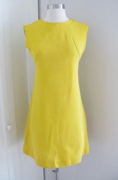 *vintage  60's bright yellow faille    sleeveless dress in about a size small/ medium  *high crew neck,    seamed bodice, slight a line skirt that falls past the knees.   back with  metal  zipper entry.  unlined. * excellent  vintage  condition tags/labels: leslie faye original measurements taken laying flat pit to pit: 16.5" waist: 14.5" hips: 18" overall length: 34" ( 2" hem) Chic Yellow Stretch Sleeveless Dress, Yellow Fitted Mod Dress, Fitted Sleeveless Mod Dress, Fitted Yellow Sleeveless Dress, Mod Style Fitted Sleeveless Summer Dress, Fitted Mod Sleeveless Summer Dress, Mod Fitted Sleeveless Summer Dress, Canary Yellow, Wiggle Dress