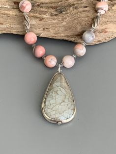 Look your best wearing this Agate necklace jewelry set!  The handmade pendant necklace and dangle earrings feature pink Botswana Agate stones, light gray crystals and silverplated components.  The beaded necklace is approximately 18 inches long and the earrings are 2.25 inches long.  The crackled gray teardrop pendant is approximately 2 inches long.  The necklace closes securely with a heart shaped, silver-plated toggle clasp.  The earrings are connected to simple, sterling silver ear wires.  The set will be a welcome addition to your jewelry collection or a lovely gift idea for someone. Available as clip on earrings, use the drop down menu to choose your option. This jewelry set is designed and handmade by me, Sharon, of Blonde Peach Jewelry. It will arrive in an attractive organza bag th Bohemian Silver Agate Beaded Necklace, Handmade Silver Agate Beaded Necklaces, Handmade Spiritual Gray Necklaces, Bohemian Gray Dangle Jewelry, Silver Beaded Agate Necklaces With Natural Stones, Silver Beaded Necklace With Stones, Silver Teardrop Gemstone Beaded Necklace, Silver Agate Beaded Necklaces For Jewelry Making, Silver Agate Gemstone Beaded Necklaces