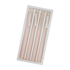 four candles in a box with tags on them