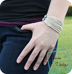 a woman's hand with a bracelet on her wrist