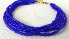 "Stunning royal blue bracelet constructed with 5 strands of high quality of seed beads. Available in several sizes and you can choose from silver or gold clasp. Find a fabulous matching necklaces here: https://www.etsy.com/shop/StephanieMartinCo/search?search_query=sapphire+blue+necklaceℴ=date_desc&view_type=gallery&ref=shop_search ❤ SIZES This item comes in several sizes, kindly choose at checkout. The standard size for an average woman is 7\". For a child, perhaps a 6\" would be approp Royal Blue Bracelet, Teal Bracelet, Beautiful Anklet, Blue Beaded Bracelets, Seed Bead Bracelet, Etsy Bridesmaid Gifts, Jewelry Essentials, Bridesmaid Bracelet, Stretchy Bracelets