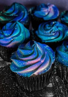 cupcakes with blue and purple frosting on top