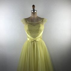 Vintage L 50s S Yellow Illusion Neckline Sweetheart Bust Bow Pleated Skirt Dress. Fits Approximately : Small; No Size Indicated - See Measurements. Bust : 34” Up To 36” With Darts Waist : 26” Bodice Length : 15.5” Overall Length : 45” Pre-Owned. Excellent Condition. Gently Worn. 0059vtg New To Poshmark? Use Code "Shesabettie" For $10 Off Your First Purchase! Fitted Tulle Skirt Tea-length Dress, Fitted Tea Length Dress With Tulle Skirt, Tea Length Tulle Skirt Dress, Fitted Yellow Sheer Dress, Yellow Fitted Sheer Dress, 1950s Style Prom Dress With Fitted Bodice, 1950s Style Dress With Sweetheart Neckline And Fitted Bodice, 1950s Style Dress With Sweetheart Neckline, 1950s Style Party Dress With Lined Bodice