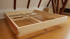 a wooden bed frame sitting on top of a hard wood floor