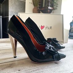 Black heels from Lanvin for H&M. They have only been worn once at a party and are in very good condition. They come in their original box with tag. Black leather, black bow and 12 cm silver heels.  Second love is saving the planet! If you have any questions please feel free to send me a message✨ Chic Patent Leather Court Shoes For Party, Leather Bow Heels For Party, Party Patent Leather Court Shoes With Padded Heel, High Heel Court Shoes With Bow For Party, Chic Bow Court Shoes For Party, Chic Party Court Shoes With Bow, Party Patent Leather Heels With Bow, High Heel Court Shoes With Bow For Evening, Glamorous Black Heels With Bow