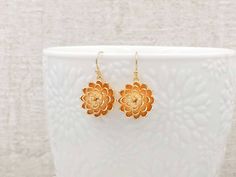 "These are pair of gorgeous and stunning gold flower earrings. The beautiful shining golden plated flowers have three layer of brush stroke textured petals with ball shaped stigma stems. The curve of the petal enhanced the inner shadow, in which emphasized the dimension of the flower. They hang underneath brass French ear wires. The earrings measure approximately (33mm) 1.3 inches from the top of the ear wires to the bottom of the flowers. They are perfect for many occasion and everyday wear. Th Gold Dangle Flower Earrings For Wedding, Gold Flower Earrings For Bridesmaid Gift, Dainty Yellow Gold Flower Earrings For Wedding, Flower Charm Wedding Earrings, Delicate Yellow Gold Flower Earrings For Wedding, Yellow Gold Flower Earrings For Wedding, Gold Flower-shaped Wedding Earrings, Yellow Gold Flower Charm Earrings For Wedding, Gold Flower Earrings For Bridesmaids