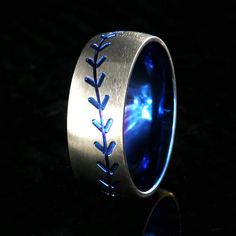 a baseball ring with blue stitching on the inside and inlayed to it