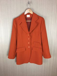 Vintage Orangle Claude Zana Jacket Made in France Women's retro clothing Wear: Good vintage condition. Measurements: Shoulders: 43 cm or 17 inch Chest: 47 cm or 18.5 inch Length: 82 cm or 32.3 inch Fitted Orange Outerwear With Notch Lapel, Orange Fitted Formal Outerwear, Formal Fitted Orange Outerwear, Classic Orange Blazer For Workwear, Classic Orange Blazer For Work, Fitted Orange Outerwear With Button Closure, Retro Outerwear With Pockets For Office, Classic Orange Outerwear For Work, Retro Formal Fall Outerwear