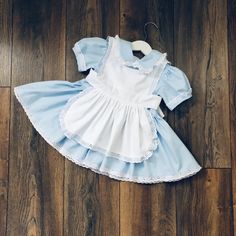 Beautiful Alice in Wonderland inspired dress, completely hand made in 100 % cotton.  The main fabric is baby blue and the contrast apron is pure white. The apron is separate so the dress can also be worn alone. I also offer a separate tutu skirt for a super full and puffy look.  I offer the dress in both standard and custom sizing. Please send a message if you would like custom fit at no extra charge. This dress is hand made to order. The estimated delivery time can be found under the shipping t Wonderland Inspired Dress, Alice In Wonderland Inspired Dress, Dress With Apron, Dress Baby Blue, Baby Blue Dress, Alice In Wonderland Inspired, Baby Blue Dresses, Marine Uniform, White Apron