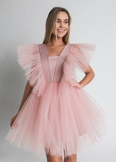 Tulle Dress for Women with Tutu Skirt and Tulle Filling on Shoulders. Perfect choice as a Bridesmaid Dress or in White as Wedding Dress. This Unique dress really puts on a show with tulle filling silhouette. Short Tulle Dress is enough to put anyone in the mood for partying. A.P.Line is more than just a custom-made clothing brand; we are the style experts, the design gurus and the professional seamstresses readily at your service. Express your individuality with a bit of modern luxury that has b Fitted Tulle Bridesmaid Dress, Sleeveless Tulle Princess Dress For Bridesmaids, Pink Sleeveless Tulle Bridesmaid Dress, Princess Style Tulle Dress For Prom Season, Princess Style Evening Dress With Tulle Skirt, Princess Style Sleeveless Tulle Bridesmaid Dress, Fitted Tulle Princess Bridesmaid Dress, Pink Tulle Dress With Sheer Bodice, Pink Bridesmaid Dress With Sheer Bodice