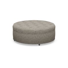 a round ottoman sitting on top of a white floor