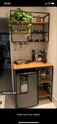 a kitchen with a refrigerator and shelves filled with bottles