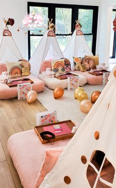 a room filled with lots of pillows and teepees on top of the floor