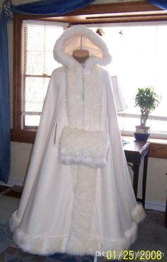 a white coat on display in front of a window