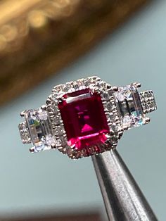 Man made emerald cut ruby, AAA grade laser cut cz set in Sterling silver, ring size 7 1/4 Red Ruby Ring With Vvs Clarity And Baguette Cut, Dazzling Ruby Ring With Vvs Clarity, Ruby Diamond Ring With Vvs Clarity And Baguette Cut, Silver Octagon Emerald Ring With Halo Setting, Dazzling Ruby Ring With Prong Setting, Emerald Cut Ruby Ring Gift, Dazzling Emerald Cut Diamond Ring With Accent Stones, Ruby Ring With Vvs Clarity And Baguette Cut, Classic Emerald Cut Diamond Ruby Ring