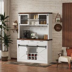 a living room with white furniture and brick walls