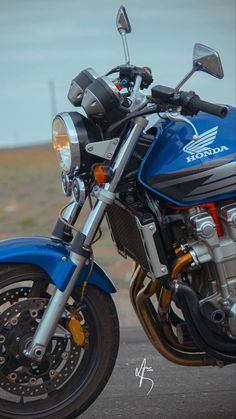 a blue motorcycle is parked on the street