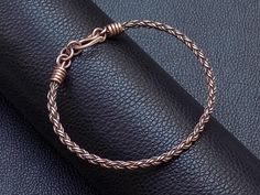 Handmade braided pure copper wire cuff men bracelet with wire wrapped end caps and copper clasp , unique and special gift for husband and wife for 7th copper wedding anniversary . Bracelet Width : 0.5 cm - 0.2" Copper is oxidized to give it an antique appearance .  Please read about copper care on Info & Faq section. The requested piece it's made to order similar with the original shown item . Please be sure to read the entire description of the item before you purchase.  Item images may seem la 7 Year Wedding Anniversary, Wedding Anniversary Gift For Husband, Copper Wedding Anniversary, Anniversary Gift For Husband, Wire Cuff, Anniversary Gifts For Husband, Casual Sport, Wedding Anniversary Gift, Gift For Husband