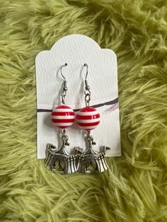 "Who would not want to wear this cute  Circus Tent Earrings. Bring the Circus life to you through this festive earrings which features charms in the shape of a circus tent and accented with a plastic red and white stripe bead.  These earrings are a great way to show the daring side of you.   Dimensions:  Earrings: 2 1/2\" Circus Tent: 20x20mm or 7/8\" Drop Length: 1 6/8 \" Great gift for any special occasions. These beautiful Earrings are ready to ship and will arrive in an organza bag, ready for gifting or safe keeping. Thank you for visiting my shop" Playful Hypoallergenic Jewelry For Party, Playful Hypoallergenic Party Jewelry, Playful Jewelry With Matching Earrings For Party, Novelty Hypoallergenic Party Earrings, Novelty Hypoallergenic Earrings For Party, Hypoallergenic Novelty Party Earrings, Hypoallergenic Novelty Earrings For Party, Playful Nickel-free Earrings For Birthday, Fun Adjustable Hoop Earrings As Gift