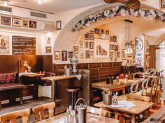 the inside of a restaurant with wooden tables and chairs