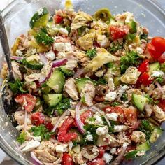 a salad in a glass bowl with a fork