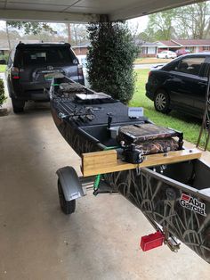 a truck is parked next to a trailer with fishing gear on the front and side