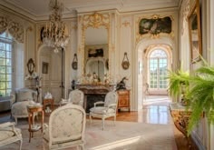 an ornately decorated living room with chandeliers and mirrors on the walls is shown