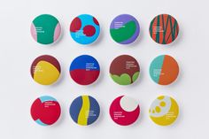 six different colored buttons with the names of each type on them, all in various shapes and sizes