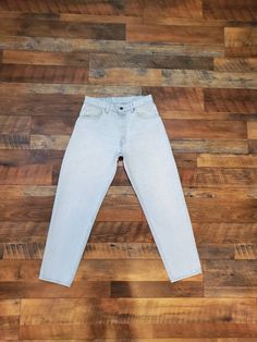 "Super beautiful light blue wash Jean, tapered leg. This are very rare. Brand: Levi's 550 Made in the USA Tag Size: 33 x 30 Measurements Waist: 30\" Hips: 42\" Rise: 11.5\" Inseam: 29.5\" Length: 39.5\" Condition: Great vintage condition well worn jeans. Size Chart to follow: 24\" Waist- US 0 25\" Waist - US 0 26\" Waist - US 2 27\" Waist - US 2 28\" Waist - US 4 29\" Waist - US 4 30\" Waist - US 6 All Sales are final. No returns , exchanges or cancellations on orders. Please review shop policie Classic Light Wash Pants For Spring, Classic Light Wash Tapered Leg Bottoms, Classic Light Wash Relaxed Fit Bottoms, Classic Tapered Leg Light Wash Bottoms, Light Wash Mid-rise Mom Fit Bottoms, Light Wash Mom Fit Mid-rise Bottoms, Classic Light Wash Cropped Pants, Spring Light Wash Pants With Standard Cut Leg, Light Wash Tapered Leg Bottoms