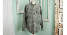 A very soft vintage cotton shirt by Abercrombie & Fitch. It feels a little heavy, like chambray. The plaid is beige with gray and light blue. The shirt has a pointy collar that buttons down. In beautiful condition - feels almost unworn! No damage, stains, or other issues. Please check measurements carefully. Condition: Excellent Vintage Tag: Abercrombie & Fitch 100% Cotton Measurements in inches.... Top of neck to bottom of shirt: 33 Chest measurement taken flat: 27 ✩ Because you don't w Vintage Brown Cotton Flannel Shirt, Vintage Cotton Shirt For Fall, Vintage Plaid Cotton Shirt, Vintage Plaid Cotton Flannel Shirt, Vintage Plaid Cotton Tops, Shabby Cottage Decor, Pointy Collar, Boho Men, Vintage Hardware