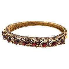 Vintage 14K Yellow Gold Garnet Bangle Bracelet - The bracelet contains 9 oval garnets that measure 6 x 4mm. The width of the bangle is 8.5mm and tapers down to 5mm and has oxidation on the side. The bracelet weighs 23.44 grams. Bracelets And Charms, On The Side, Vintage Watches, Bangle Bracelet, Antique Jewelry, Vintage Antiques, Garnet, Gemstone Jewelry, Bangle Bracelets