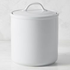 a large white pot sitting on top of a counter