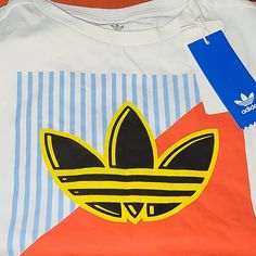 White Kids Graphic Tee 9/10 Yrs. Adidas Multicolor Graphic Print T-shirt, Adidas Multicolor Crew Neck T-shirt, Yellow Sporty Top With Logo Print, Retro White Top With Three Stripes, Sporty Yellow Long Sleeve T-shirt, White Retro Top With Three Stripes, Yellow Adidas Crew Neck Top, Adidas Yellow Crew Neck Top, White Adidas Shirt For Summer