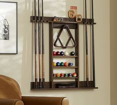 a room with pool cues, cues and other items on the wall next to a chair