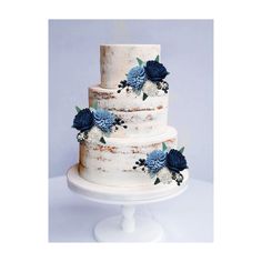 a three tiered cake with blue flowers on it