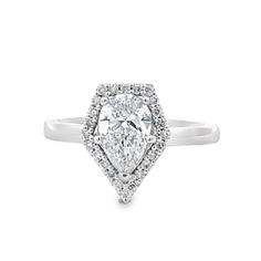 a pear shaped diamond ring with halos on the shoulders and sides, set in white gold