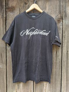 A classic and rare vintage skate tee. Features nicely distressed black cotton, the 'Neighborhood' logo front & center, small Stussy graphic on the left sleeve, a comfy oversize fit, and lots of retro streetwear chic. A cool collectible and great gift. Brand : STUSSY Neighborhood 'Boneyards' 100% cotton Made in Mexico of US components Labeled size XL (I'd say Men's XL, Ladies' 2XL) All measurements taken with garment lying flat, double where necessary 23 inches shoulder seam to shoulder seam 23.5 Washed Black Graffiti Print T-shirt For Streetwear, Washed Black Graffiti Print Top For Streetwear, Washed Black Graffiti Print Grunge T-shirt, Washed Black Grunge T-shirt With Graffiti Print, Grunge Washed Black T-shirt With Graffiti Print, Urban Black T-shirt For Skateboarding, Black Urban T-shirt For Skateboarding, Relaxed Fit Grunge T-shirt For Streetwear, Grunge Relaxed Fit T-shirt For Streetwear