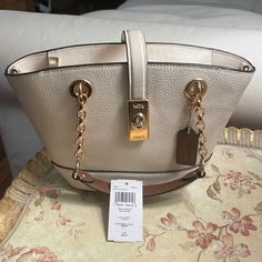 Excellent Condition With Tag And Long Strap Cream Base With Brown Straps And Gold Hardware Elegant Cream Bucket Bag For Shopping, Elegant White Bucket Satchel, Coach Cream Evening Bag, Coach Beige Bucket Bag For Shopping, Elegant White Bucket Bag With Gold-tone Hardware, White Evening Bucket Bag With Gold-tone Hardware, Elegant White Tote Bucket Bag, Elegant White Bucket Bag For Formal Occasions, Formal White Double Handle Bucket Bag