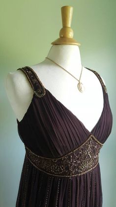 Shimmer and shine 🎆 This flapper-inspired dress features a rich brown, sheer, silk-crepe overlay with intricate copper beading; a flattering shirred, gathered bodice and jeweled straps; a floaty skirt with rows of beads accenting the pleating; and a jeweled high waist. Lined; hidden side zip. New and never worn with original store tag still attached. Fits medium sizes; pictured on a US size 6/8 dress form. Era: 1990s Label: D'Albert Flapper Inspired Dress, 1930s Gown, Colorado Girl, Beaded Flapper Dress, Gathered Bodice, Satin Shoes, Brown Silk, Formal Party, Dress Form