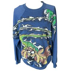 Vtg 90s Looney Tunes Blue Green Taz Tasmanian Devil Sweatshirt Men Medium 1996 Crewneck Long Sleeve Top In Great Condition. There Is A Small Hole On The Front And The Graphic Is Slightly Faded But Otherwise Classic 90s Top That Is So Soft And Comfy. Perfect For Streetwear Comfy Athleisure 90s Retro Style. Items That Are Preused/Preworn Are Not In Perfect Condition. Please Look At The Pictures Carefully For Condition. Items That Are Nwt May Contain Flaws, But They Will Be Noted In The Description. Don’t See Measurements? Feel Free To Ask Me And Allow 24-48 Hours Response Time. Items Come From A Smoke Free Home. When Possible, I Reuse Packaging To Ship And Protect Your Purchases. Let Vintage Blue Sweatshirt With Graphic Print, Blue 90s Style Tops For Fall, 90s Blue Tops With Graphic Print, 90s Blue Streetwear Tops, 90s Oversized Blue Top, 90s Blue Oversized Top, Oversized 90s Blue Top, 90s Style Oversized Blue Top, Blue Oversized 90s Style Top