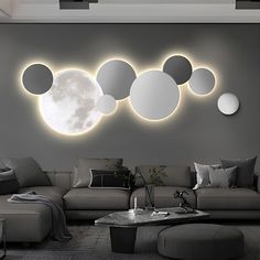 a modern living room with round mirrors on the wall and couches in front of it