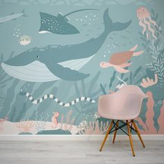 a room with a chair and wallpaper that has an underwater scene on the wall