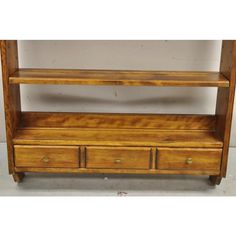 a wooden shelf with two drawers on it