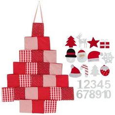 a christmas tree made out of red and white squares with santa's hats on top